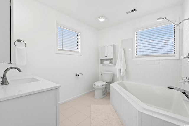 bathroom featuring vanity, plenty of natural light, tile patterned floors, and toilet