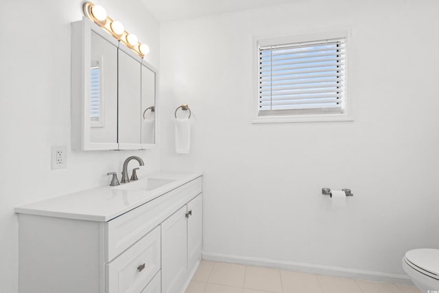 bathroom featuring vanity, toilet, and tile patterned flooring