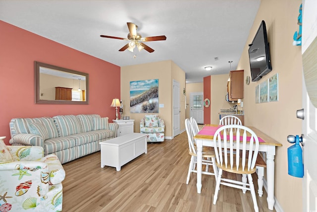 living room featuring ceiling fan and light wood-type flooring