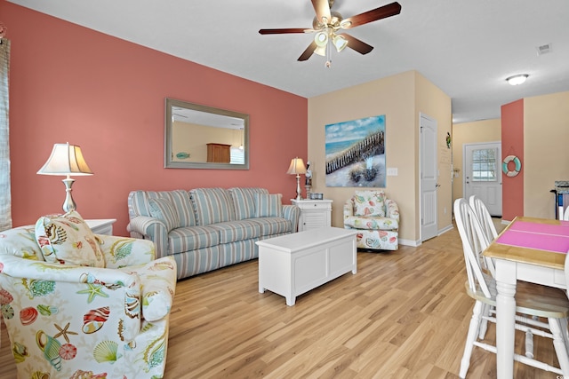 living room featuring ceiling fan and light wood-type flooring