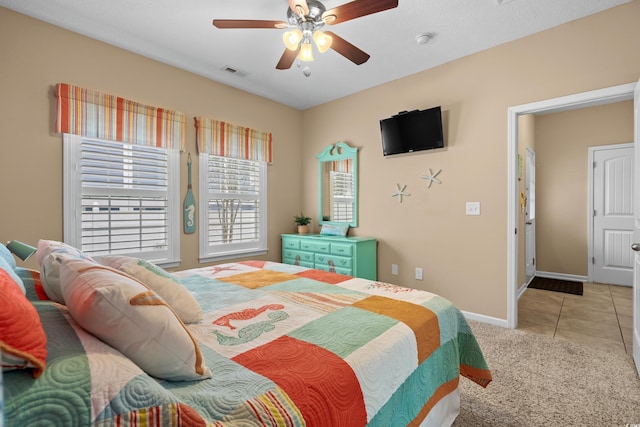 tiled bedroom featuring ceiling fan