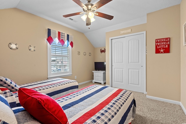 carpeted bedroom with ceiling fan, vaulted ceiling, and a closet