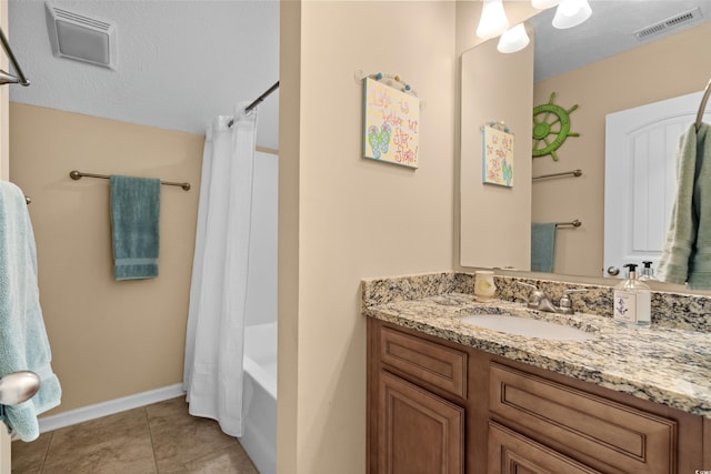 bathroom featuring vanity, shower / bathtub combination with curtain, and tile patterned floors