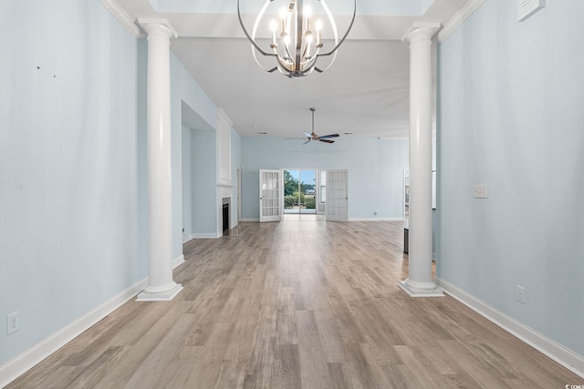 interior space featuring ornate columns, a chandelier, and light hardwood / wood-style floors