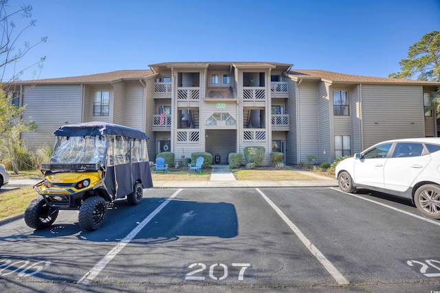 view of property featuring uncovered parking