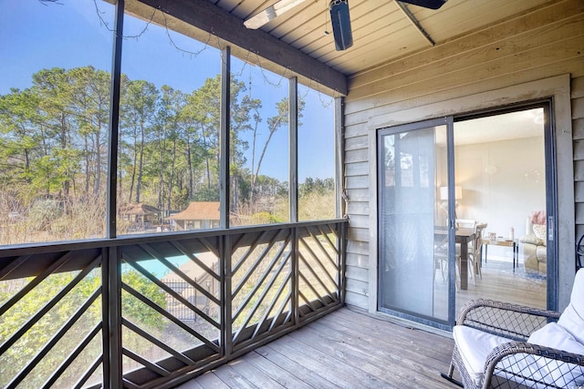 unfurnished sunroom with ceiling fan and wood ceiling