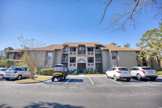 view of building exterior featuring uncovered parking