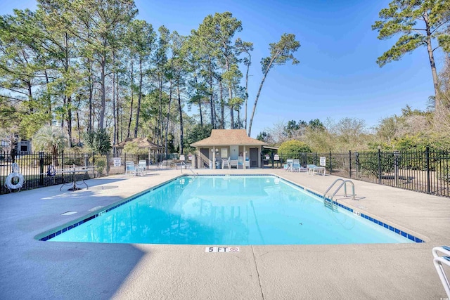 pool featuring fence and a patio
