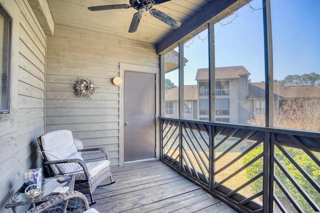 sunroom / solarium with wood ceiling and a ceiling fan