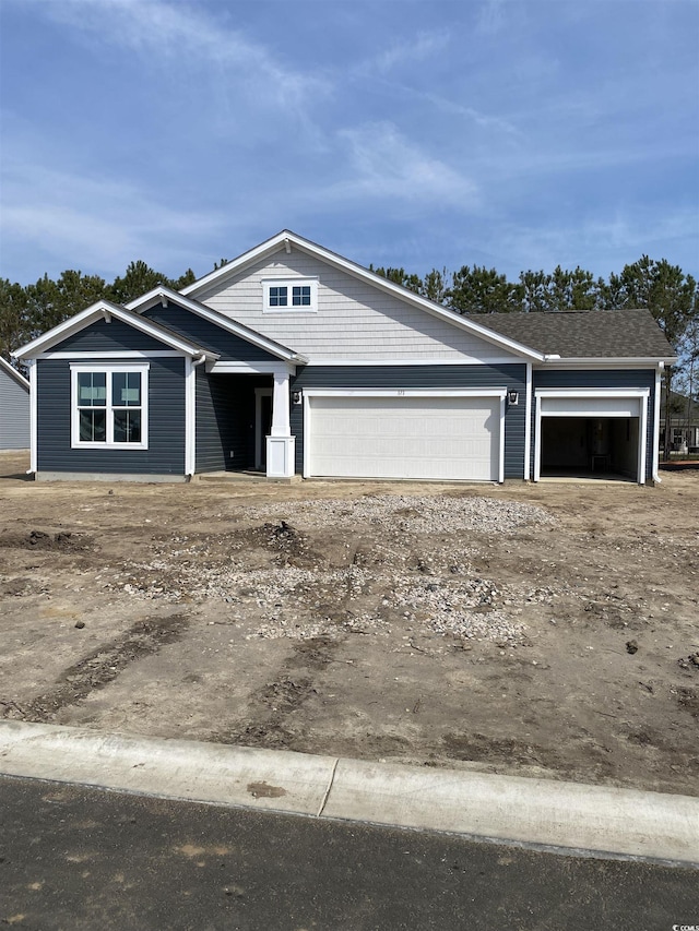 craftsman-style house with a garage and driveway