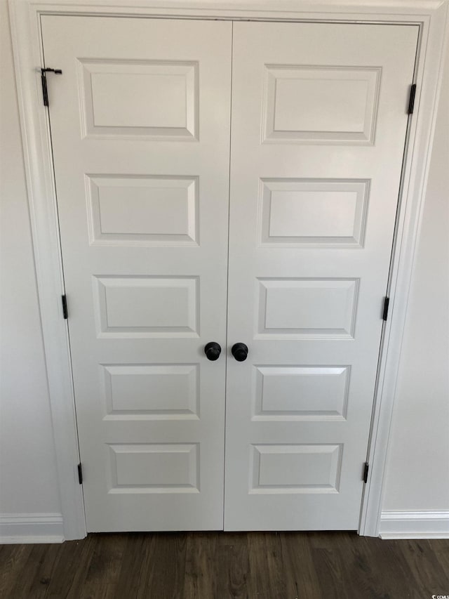 detailed view of baseboards and wood finished floors