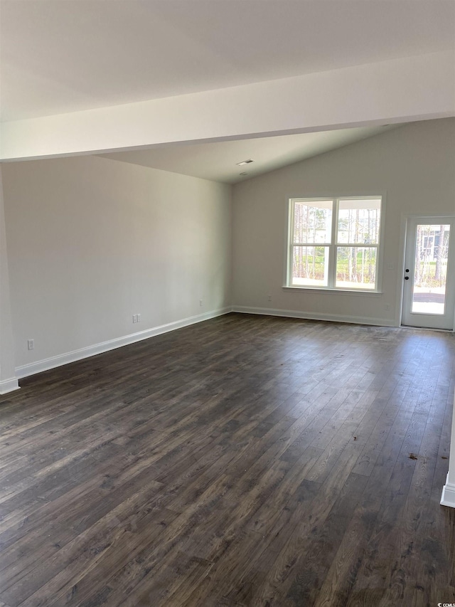 unfurnished room featuring dark wood finished floors, plenty of natural light, vaulted ceiling, and baseboards