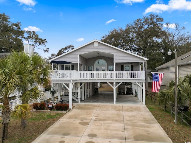 raised beach house featuring a carport and covered porch