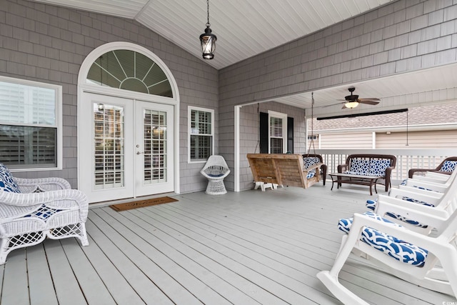 deck with outdoor lounge area, ceiling fan, and french doors