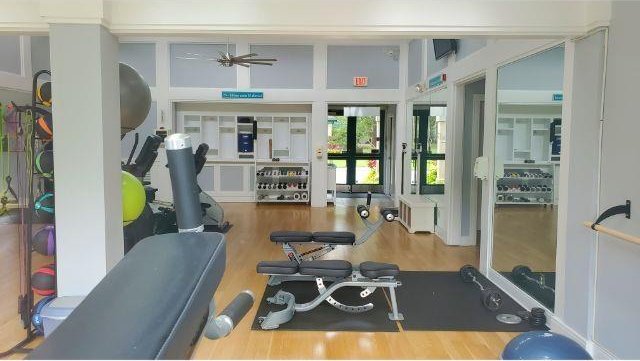 exercise room with hardwood / wood-style flooring and ceiling fan