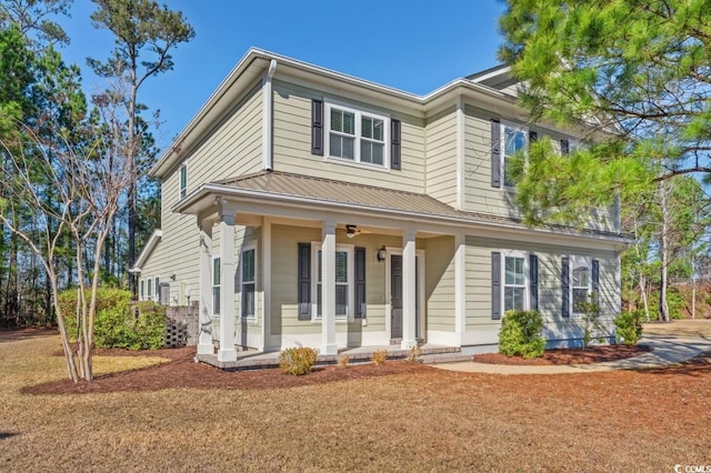 view of front of house featuring covered porch and a front yard