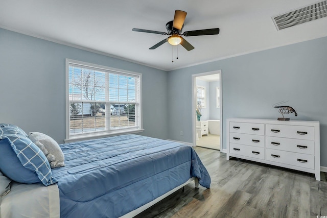 bedroom with visible vents, ceiling fan, baseboards, and wood finished floors