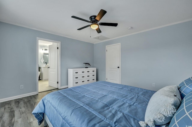 bedroom featuring ceiling fan, ensuite bathroom, wood finished floors, baseboards, and ornamental molding