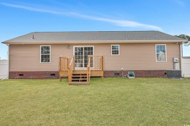 back of property with crawl space, roof with shingles, a yard, and a wooden deck