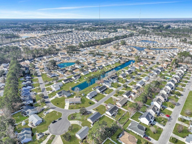 birds eye view of property with a residential view and a water view