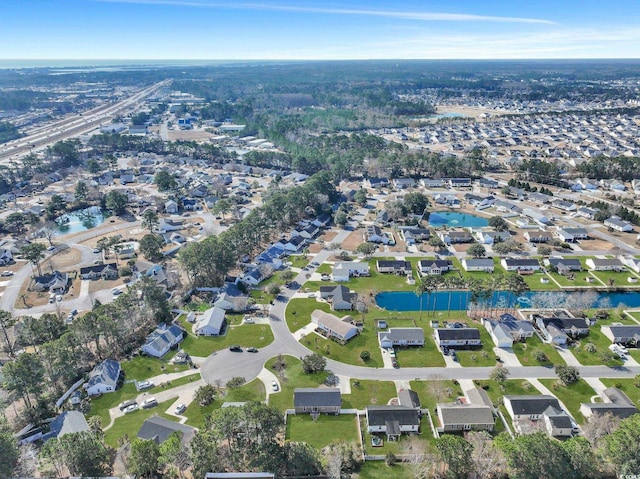 drone / aerial view featuring a water view and a residential view