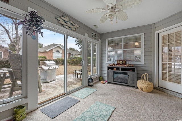 sunroom featuring ceiling fan