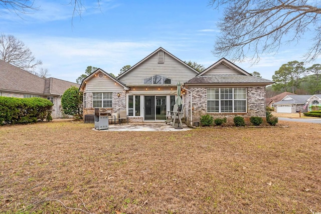 rear view of property with a patio area and a lawn