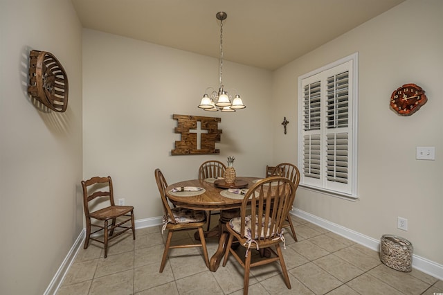 dining space featuring light tile patterned floors and an inviting chandelier