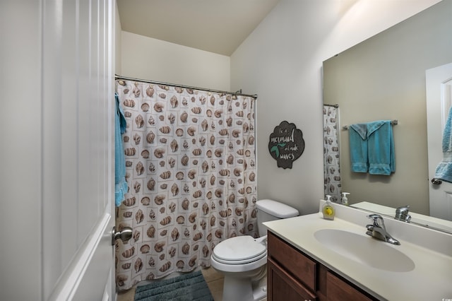 bathroom featuring toilet, vanity, and tile patterned flooring