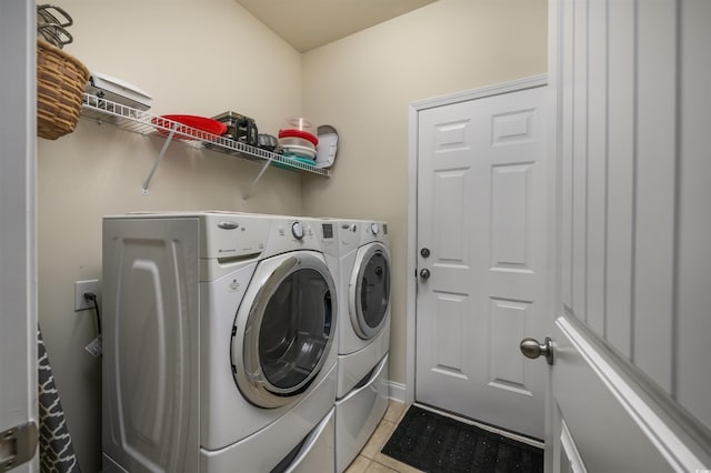 washroom featuring washer and dryer and light tile patterned floors