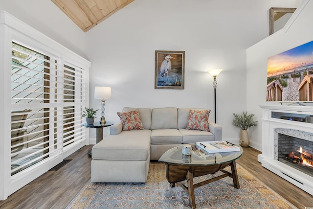 living room featuring wood ceiling, ornamental molding, wood-type flooring, and high vaulted ceiling