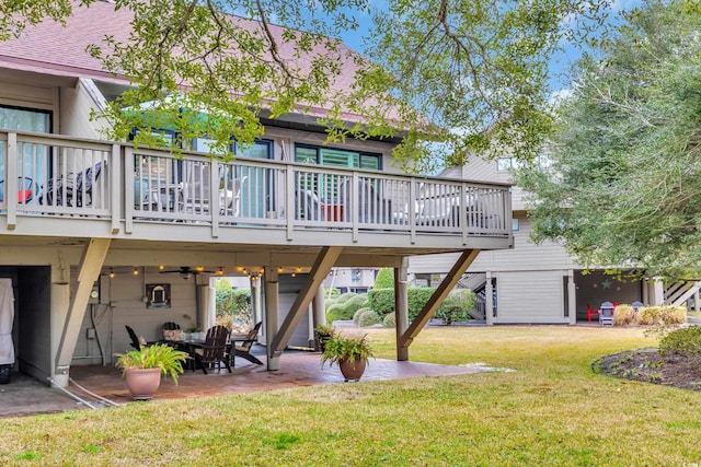 rear view of house featuring a yard, a patio area, and a deck