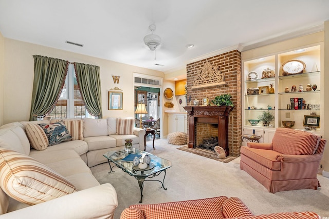 living room featuring ceiling fan, light carpet, a fireplace, and built in shelves