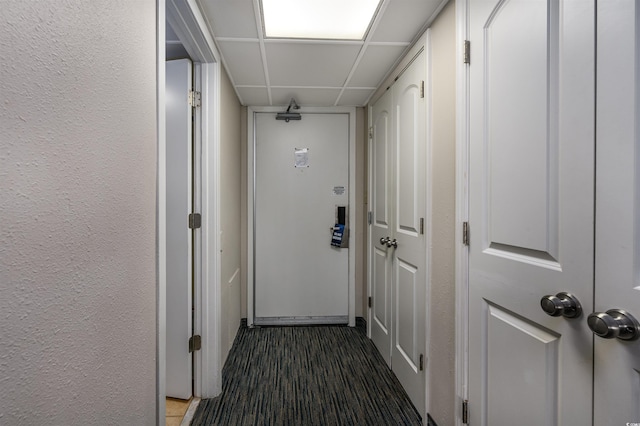 hallway with a drop ceiling