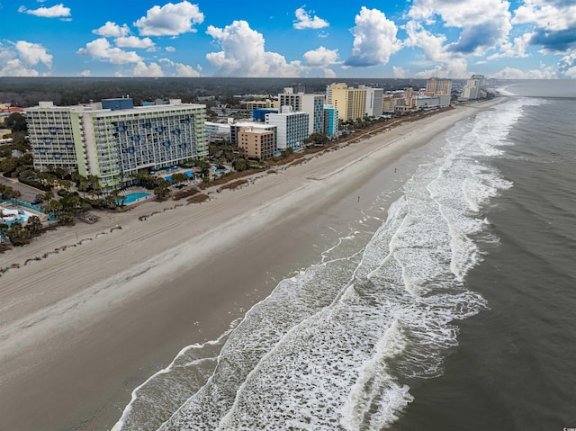 drone / aerial view with a water view and a beach view