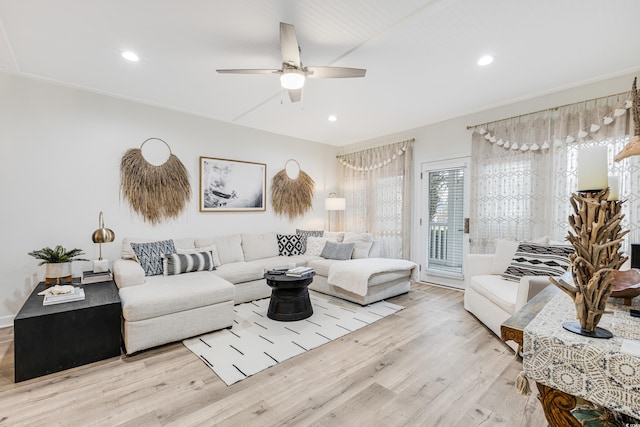 living room with light hardwood / wood-style floors and ceiling fan