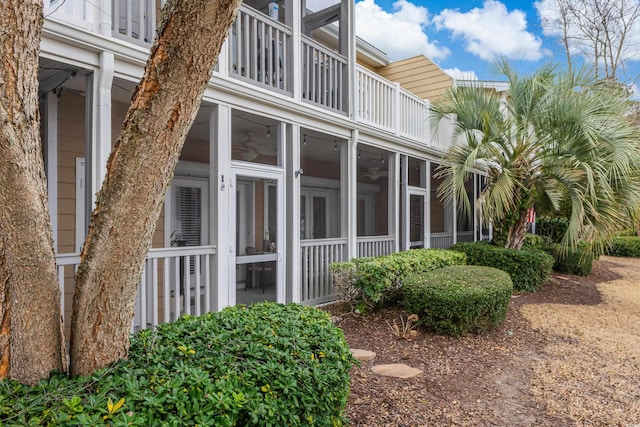 view of property exterior with a sunroom