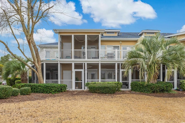 back of house with a balcony and a sunroom