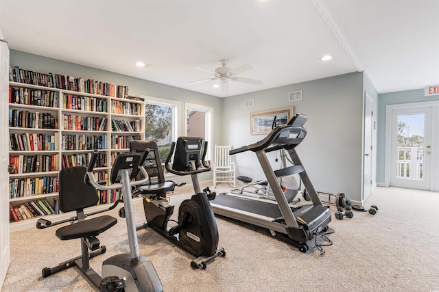 exercise area with light colored carpet and ceiling fan