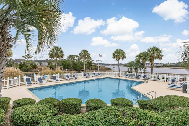 view of swimming pool featuring a patio area and a water view