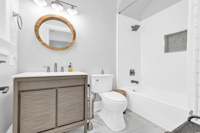 bathroom featuring baseboards, toilet, marble finish floor, vanity, and shower / washtub combination