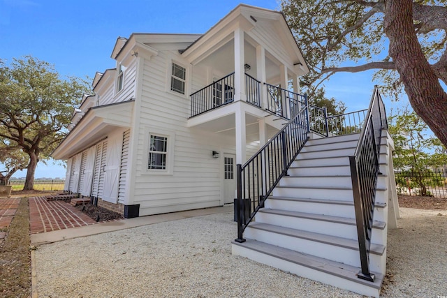 exterior space with stairway and a balcony
