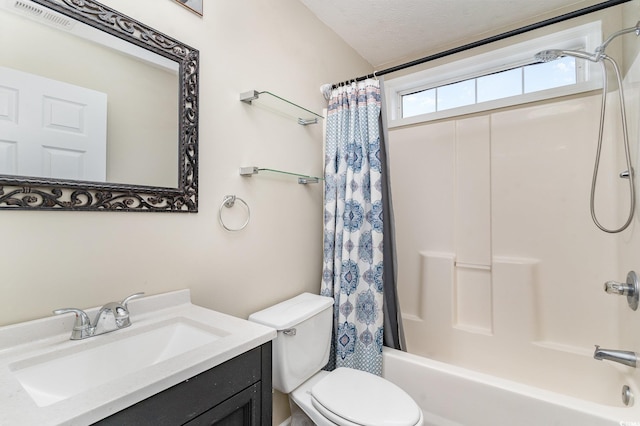 full bathroom featuring vanity, a textured ceiling, shower / bath combination with curtain, and toilet