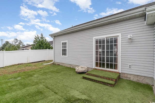 rear view of house with a yard