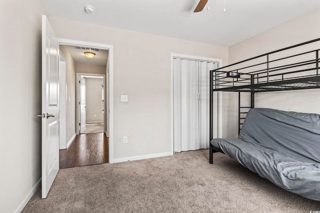 carpeted bedroom featuring a closet and ceiling fan