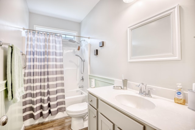 full bathroom featuring vanity, hardwood / wood-style flooring, shower / bath combo, and toilet