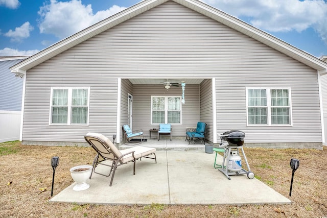 rear view of property with a patio area, ceiling fan, and a lawn