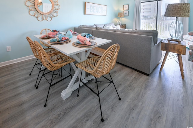 dining space with dark hardwood / wood-style flooring