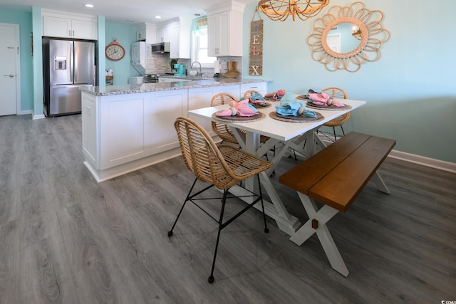 dining room featuring hardwood / wood-style floors and sink