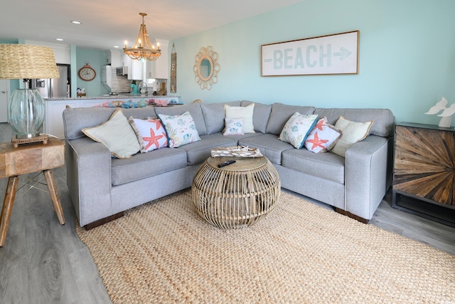 living room with an inviting chandelier and wood-type flooring